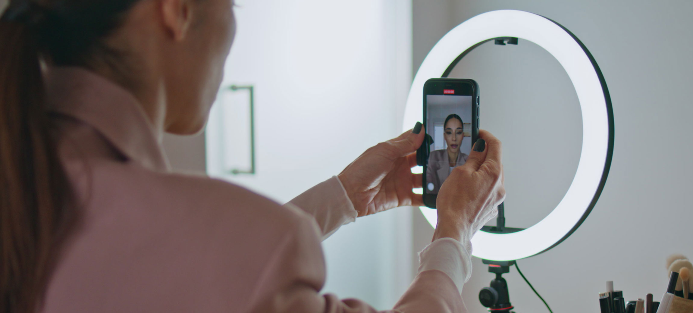 Closeup influencer adjusting smartphone